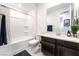 Clean bathroom with shower-tub combo and dark wood vanity with solid surface countertop at 212 Harris Peak St, Las Vegas, NV 89138
