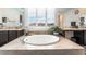 Close-up on bright bathroom with soaking tub and dual vanities under natural light at 212 Harris Peak St, Las Vegas, NV 89138