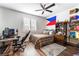 Bedroom with natural wood floors, filled with collectibles and decor, and equipped with a desk at 212 Harris Peak St, Las Vegas, NV 89138