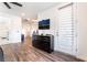 Bright bedroom has a large dresser with TV, wood floors, and white walls at 212 Harris Peak St, Las Vegas, NV 89138