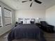This bedroom features a ceiling fan, window with shades, and a comfortable bed at 212 Harris Peak St, Las Vegas, NV 89138