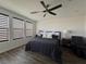 This bedroom features a ceiling fan, window with shades, and a comfortable bed at 212 Harris Peak St, Las Vegas, NV 89138