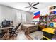 The bedroom boasts neutral walls and wood-look flooring. A desk and bookcase provide functional storage at 212 Harris Peak St, Las Vegas, NV 89138