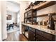 Butler pantry with sleek cabinetry, granite countertops, and open shelving at 212 Harris Peak St, Las Vegas, NV 89138