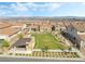 Scenic aerial view of neighborhood green space, surrounded by houses with Spanish tile roofs at 212 Harris Peak St, Las Vegas, NV 89138