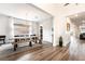Bright dining room featuring tile accent wall, modern lighting, and an adjacent butler's pantry at 212 Harris Peak St, Las Vegas, NV 89138