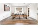 Modern dining room with dark wood flooring, a long table, and unique light fixture at 212 Harris Peak St, Las Vegas, NV 89138