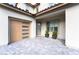 Welcoming entrance with a modern front door, stylish garage door, and well-placed plants at 212 Harris Peak St, Las Vegas, NV 89138