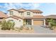 Charming two-story home with a well-manicured front yard and a modern garage door at 212 Harris Peak St, Las Vegas, NV 89138