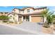 Two story home featuring desert landscaping and a two-car garage with modern-style door and a paved driveway at 212 Harris Peak St, Las Vegas, NV 89138