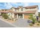 Inviting two-story home with a landscaped front yard and a modern garage door at 212 Harris Peak St, Las Vegas, NV 89138