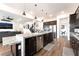 Open-concept kitchen and living room with expansive island and seating at 212 Harris Peak St, Las Vegas, NV 89138