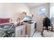 Functional laundry room with sink, modern washer and dryer, and natural light at 212 Harris Peak St, Las Vegas, NV 89138