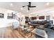 Open-concept living room with modern furniture, dark cabinets, and a staircase at 212 Harris Peak St, Las Vegas, NV 89138