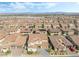 Wide aerial shot showcasing the neighborhood, featuring houses with tile roofs and lush landscaping at 212 Harris Peak St, Las Vegas, NV 89138