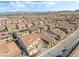 Wide aerial shot showcasing the neighborhood, many houses with Spanish tile roofs at 212 Harris Peak St, Las Vegas, NV 89138
