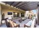Cozy covered patio featuring a TV, comfortable seating, and sliding glass doors at 212 Harris Peak St, Las Vegas, NV 89138
