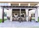 Charming patio with a pergola, stylish curtains, and comfortable outdoor furniture at 212 Harris Peak St, Las Vegas, NV 89138