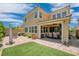 Inviting backyard with a covered patio, outdoor seating, manicured lawn, and desert landscaping at 2154 Tortona St, Henderson, NV 89044