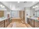 Modern bathroom featuring double vanity sinks, a soaking tub, and a walk-in shower at 2154 Tortona St, Henderson, NV 89044