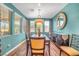 Bright dining room with a modern light fixture, large windows, and stylish decor at 2154 Tortona St, Henderson, NV 89044