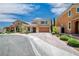 Charming two-story home featuring a well-manicured lawn, a paved driveway, and a two-car garage at 2154 Tortona St, Henderson, NV 89044