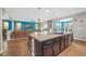 Open-concept kitchen with a large island, granite countertops, and seamless flow into the living area at 2154 Tortona St, Henderson, NV 89044