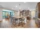 Modern kitchen featuring dark cabinets, granite countertops, a large island, and stainless steel appliances at 2154 Tortona St, Henderson, NV 89044