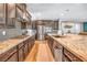 Contemporary kitchen featuring stainless steel appliances, granite countertops, and dark wood cabinetry at 2154 Tortona St, Henderson, NV 89044