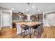 Stylish kitchen showcasing a spacious island with bar seating, dark wood cabinets, and modern lighting at 2154 Tortona St, Henderson, NV 89044