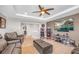 Upstairs living area with comfortable leather seating, entertainment center, and a ceiling fan at 2154 Tortona St, Henderson, NV 89044