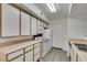 Bright kitchen featuring white cabinetry, appliances, and modern flooring at 2300 E Silverado Ranch Blvd # 1070, Las Vegas, NV 89183