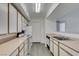 Bright kitchen featuring white cabinets, appliances and modern flooring at 2300 E Silverado Ranch Blvd # 1070, Las Vegas, NV 89183