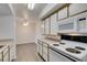 Well-lit kitchen features white cabinets and modern appliances at 2300 E Silverado Ranch Blvd # 1070, Las Vegas, NV 89183