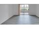 A bright, empty living room features modern floors and a balcony access door at 2300 E Silverado Ranch Blvd # 1070, Las Vegas, NV 89183
