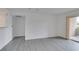 An empty living room features new floors and a sliding door to a balcony at 2300 E Silverado Ranch Blvd # 1070, Las Vegas, NV 89183