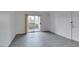 An empty living room with wood-look floors and sliding door to balcony at 2300 E Silverado Ranch Blvd # 1070, Las Vegas, NV 89183