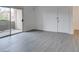 A light and airy living room with wood look floors and balcony access at 2300 E Silverado Ranch Blvd # 1070, Las Vegas, NV 89183