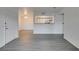 The open-concept living space features modern gray wood-look flooring and bright neutral walls at 2300 E Silverado Ranch Blvd # 1070, Las Vegas, NV 89183