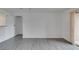 Open-concept living area with gray wood-look flooring and bright neutral walls at 2300 E Silverado Ranch Blvd # 1070, Las Vegas, NV 89183