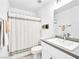 Clean bathroom featuring a shower with a white curtain, vanity with a sink, and neutral decor at 2337 Sierra Sunrise St, Las Vegas, NV 89156