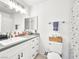 Well-lit bathroom featuring modern vanity, granite countertops, and shower with a stylish shower curtain at 2337 Sierra Sunrise St, Las Vegas, NV 89156
