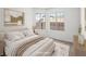 Serene bedroom featuring neutral tones, plush bedding, and ample natural light from two windows at 2337 Sierra Sunrise St, Las Vegas, NV 89156