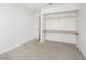 Empty bedroom with carpet, a door and an integrated closet with shelves and a hanging rail at 2337 Sierra Sunrise St, Las Vegas, NV 89156