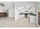 Open-concept living space featuring a modern kitchen with white cabinetry, stainless steel appliances, and an adjacent living area at 2337 Sierra Sunrise St, Las Vegas, NV 89156