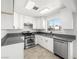 Well-lit kitchen featuring white cabinets, stainless steel appliances, and a modern faucet at 2337 Sierra Sunrise St, Las Vegas, NV 89156