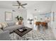 Bright living room with modern furniture, a ceiling fan, and a dining area flooded with natural light at 2337 Sierra Sunrise St, Las Vegas, NV 89156