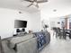 Bright and airy living room featuring tile floors, a ceiling fan, and an open layout flowing to the kitchen and dining area at 2337 Sierra Sunrise St, Las Vegas, NV 89156