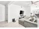 Open living room with a gray sofa, flat-screen TV, and tile flooring at 2337 Sierra Sunrise St, Las Vegas, NV 89156