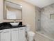 Updated bathroom with a gray-tiled walk-in shower, modern vanity, and elegant finishes for a luxurious feel at 2375 Marion St, Las Vegas, NV 89104